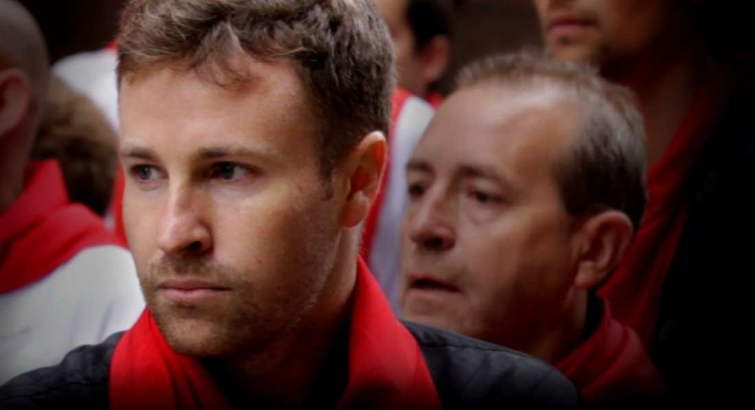 A runner in a red pañuelo in the San Fermín crowd in Pamplona, from Chasing Red